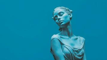 a blue statue of a girl with a blue background photo