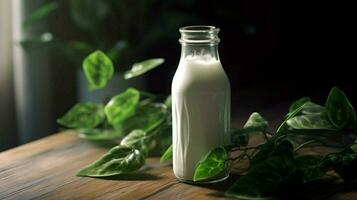 a bottle of milk with a black cap sits on a table photo