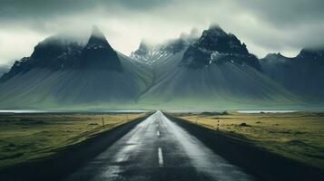 an empty road with mountains in the background photo