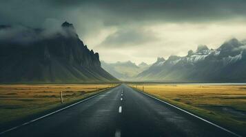 an empty road with mountains in the background photo