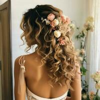 Curly half-up ponytail with a floral accessory photo