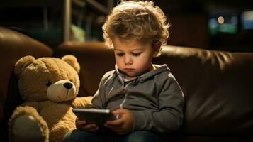 A little boy immersed in the digital world uses a phone while sitting on the sofa. Generative AI photo