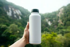 Hands holding a white bottle of whey protein on nature background photo