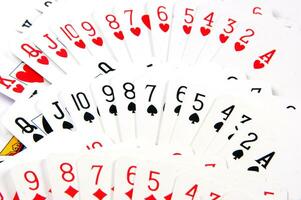 a pile of playing cards on a table photo