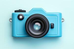 Vintage film camera on blue background. Top view with copy space photo