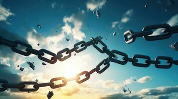 Conceptual image of broken chain against blue sky with white clouds photo