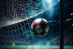 Soccer ball in net against football stadium under spotlights photo