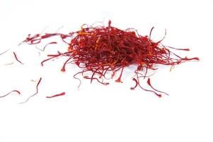 a pile of red saffron on a white background photo