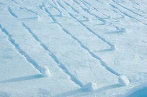 a snowboarder is riding down a slope photo