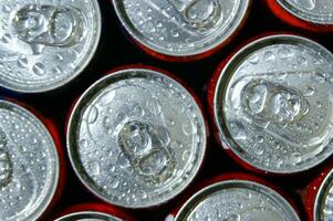 a close up of cans of soda photo