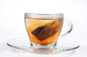 a glass cup with a tea bag in it photo