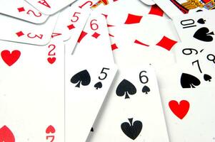 a pile of playing cards on a table photo