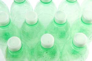 plastic bottles are scattered on a white surface photo