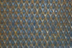 a close up of a metal surface with blue and yellow colors photo