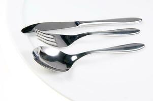 a bunch of silver forks and knives photo