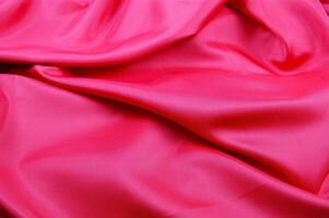 a close up of a bright pink satin fabric photo