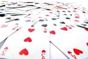 a pile of playing cards on a table photo