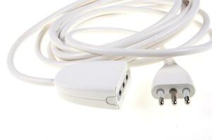 a white cable with two plugs on a white surface photo
