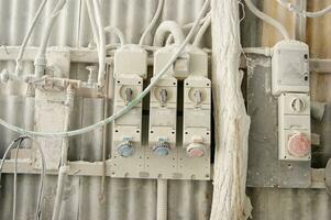 a bunch of wires and switches attached to a wall photo