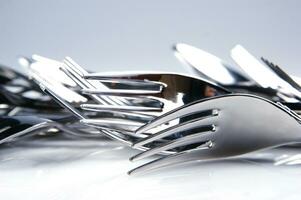 a bunch of silver forks and knives photo