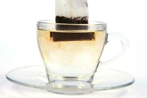 a glass cup with a tea bag in it photo