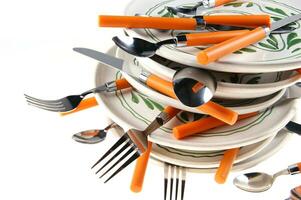 a stack of plates with spoons on top photo