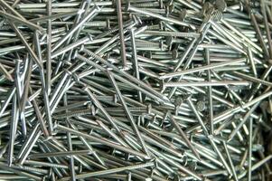 a pile of nails with a variety of sizes photo