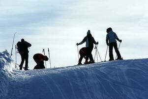 a group of people standing on a snow covered slope photo