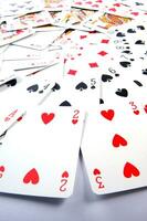 a pile of playing cards on a table photo