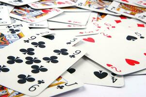 a pile of playing cards on a table photo