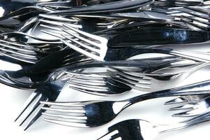 a bunch of silver forks and knives photo