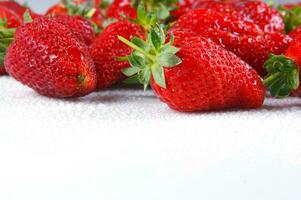 a glass bowl filled with strawberries photo