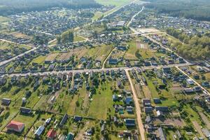 aerial view on provincial city or big village housing area with many buildings, roads and garden. photo