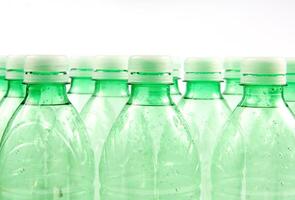 plastic bottles are scattered on a white surface photo