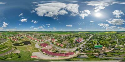 aerial full seamless spherical hdri 360 panorama from great height on red roofs of center of small city or countyside  in equirectangular projection. May use like skydome replacement for drone shots photo