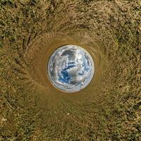 blue hole sphere little planet inside green grass round frame background. photo