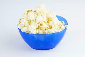 four colorful bowls of popcorn on a white surface photo