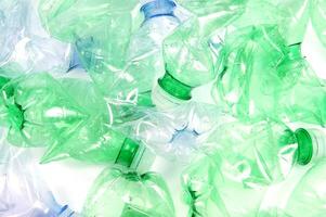 plastic bottles are scattered on a white surface photo