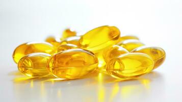 Transparent yellow vitamins on a light background. Vitamin D, omega 3, omega 6, Food supplement oil filled fish oil, vitamin A, vitamin E, flaxseed oil. photo