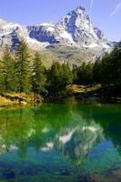 reflections of the cervino mountain in the blue lake photo