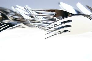 a bunch of silver forks and knives photo