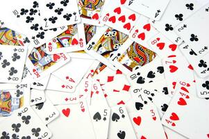 a pile of playing cards on a table photo