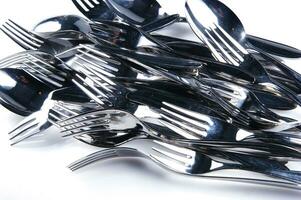 a bunch of silver forks and knives photo