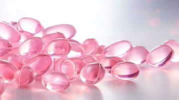 Pink transparent vitamins on a light background photo
