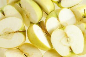 a bunch of apples cut in half photo