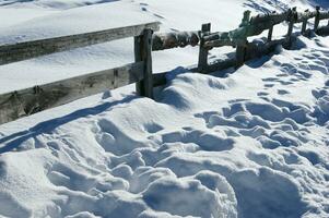 un de madera cerca con un nieve cubierto suelo foto