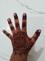 Beautiful mehedi design on a hand with white background photo