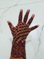 Beautiful mehedi design on a hand with white background photo