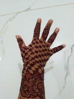 Beautiful mehedi design on a hand with white background photo