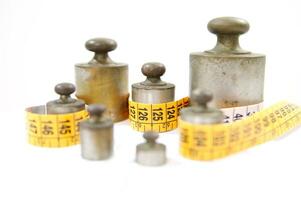 old weights for scales and tape measure to control the diet photo